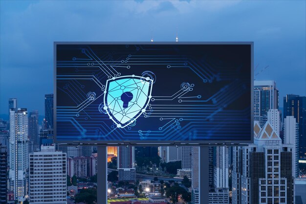 Padlock icon hologram on road billboard over panorama city view of Kuala Lumpur at night to protect business Malaysia Asia The concept of information security shields