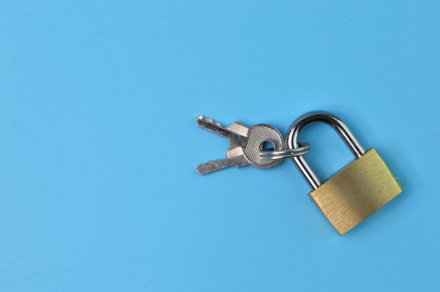 Padlock and keys isolated on a blue background