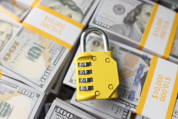 Padlock with combination on background of dollar banknotes financial security money protection