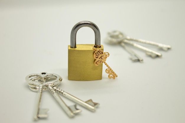 Padlock with keys on gray surface