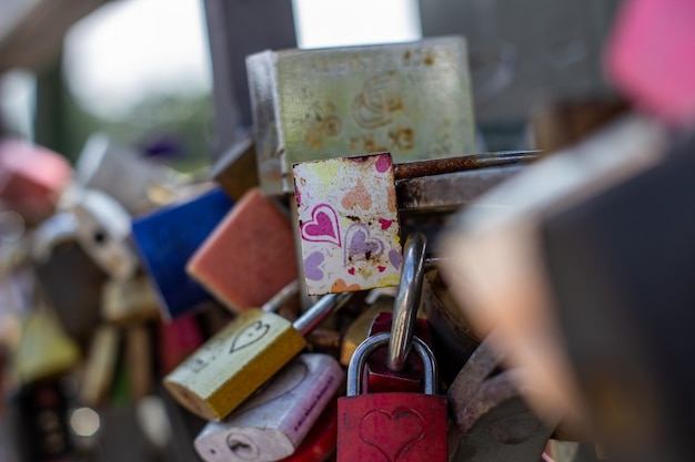 Padlocks on a bridge in frankfurt am main, germany. the ritual\
of attaching padlocks as a symbol of love to a bridge has been\
common in europe since the 2000s.