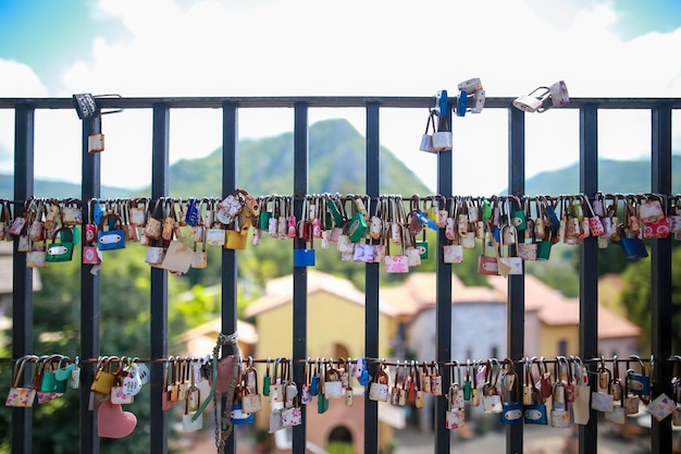 Photo padlocks hanging on railing against fence