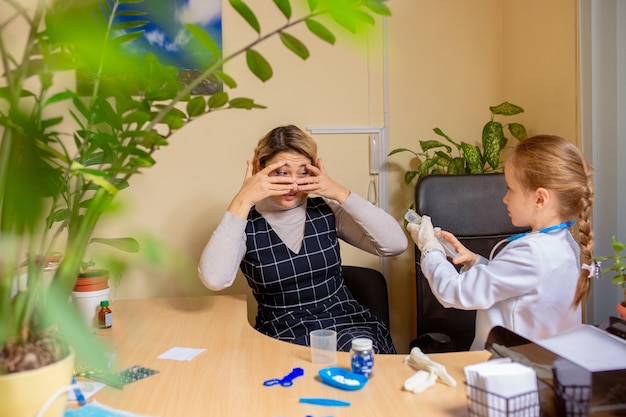 Paediatrician doctor examining a child in comfortabe medical office.