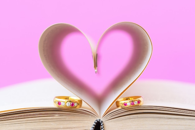 Pages of book curved  heart shape and weeding ring