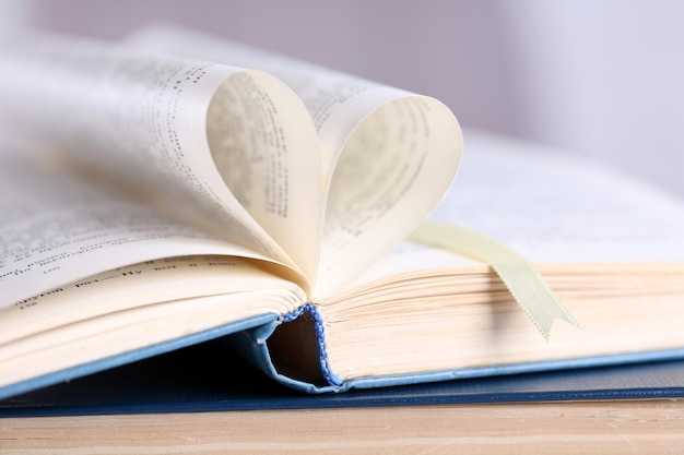 Pages of book curved into heart shape, close up