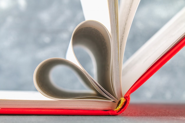 The pages of the book in the red cover are made in the form of a heart. The concept Valentine's Day.