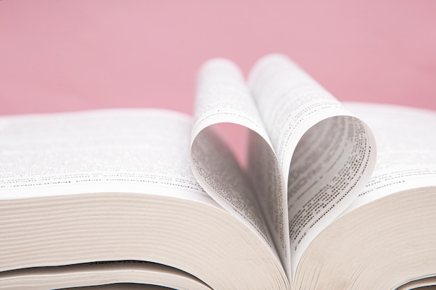 Pages of a book wrapped in a heart. Close up.