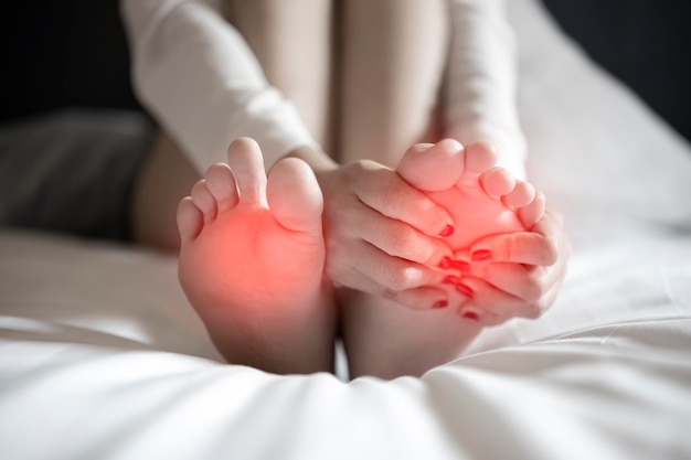 Pain in the foot girl holds her hands to her feet foot massage