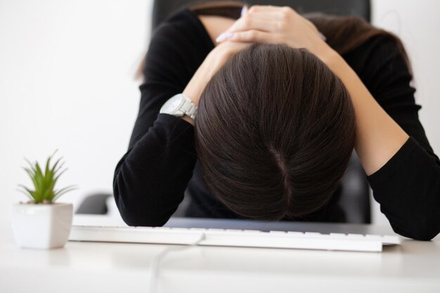 Pain neck Tired business woman holding her neck