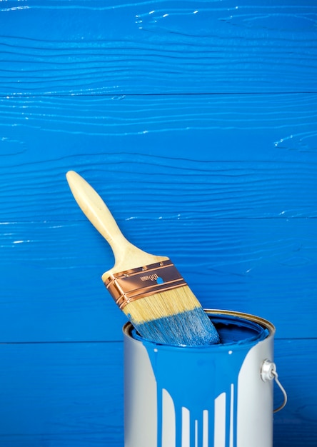 Paint brush in blue color oil paint can