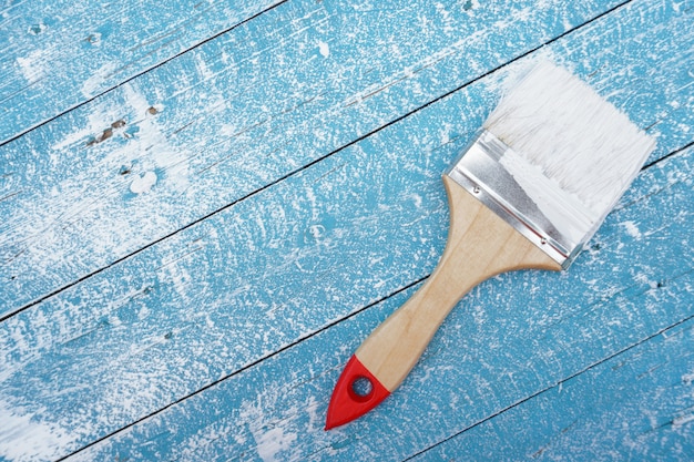 Paint brush on blue wood floor