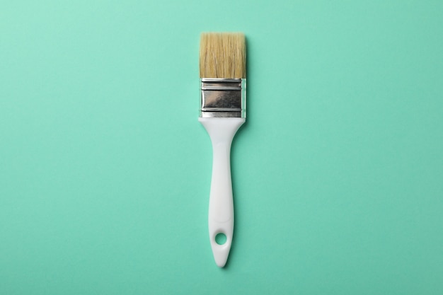 Paint brush on green surface