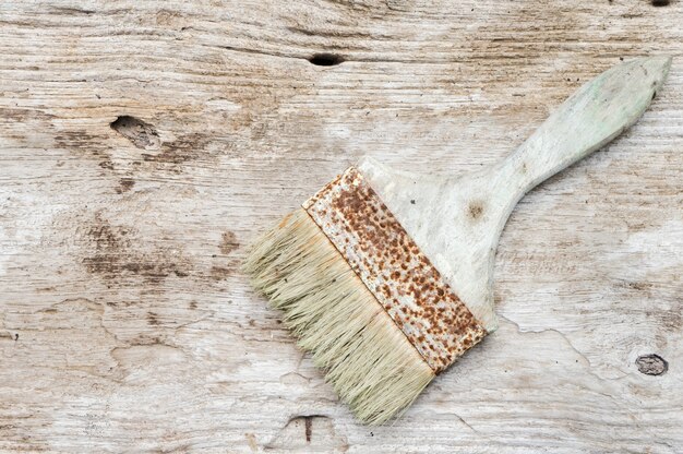 Paint brush on old wood table background