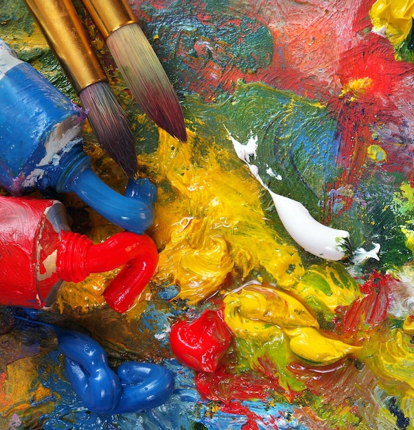 a paint brush and paint brushes are on a table.