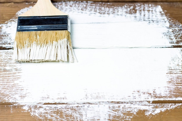 Paint brush on a painted wooden surface background copy space