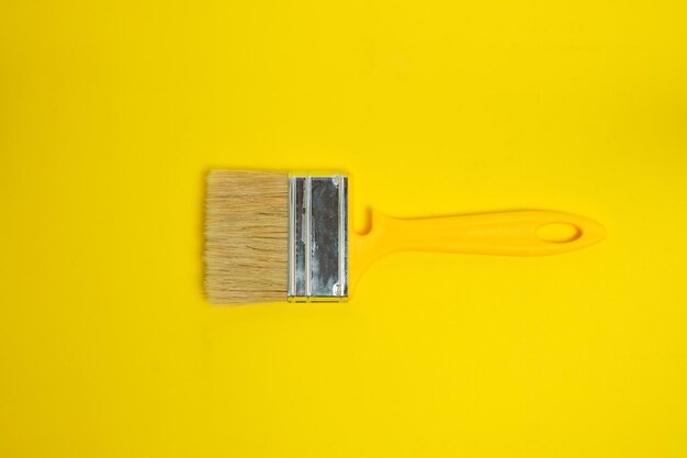 Paint brush for painting and repair on a yellow background