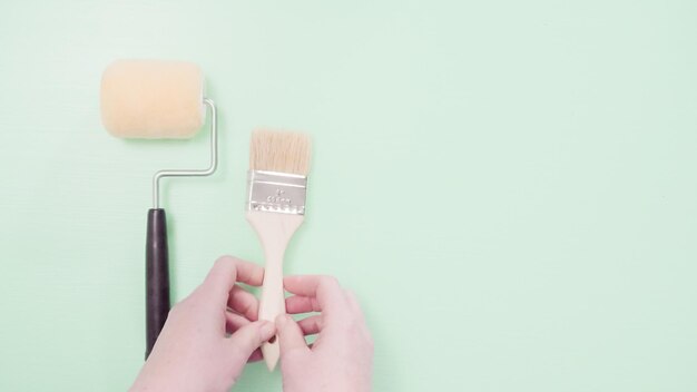 Paint brush and roller for house painting project.