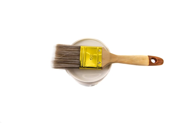 Paint brush on top of a paint pot isolated on white background