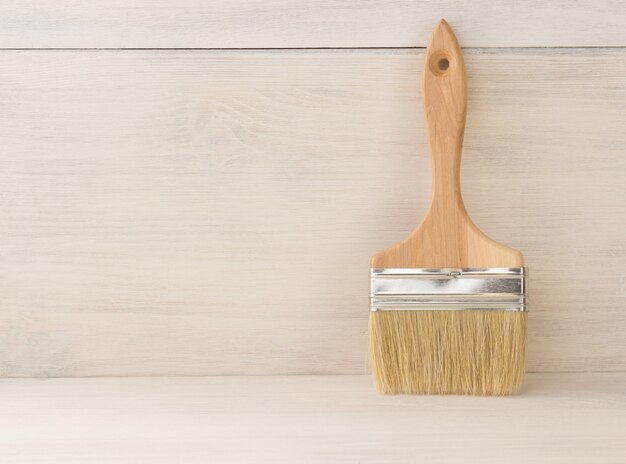 Paint brush  on wooden wall