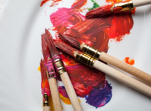 paint brushes on a white background in red paint watercolor brushes in paint