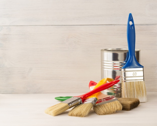 Photo paint bucket and paintbrush  on wooden background