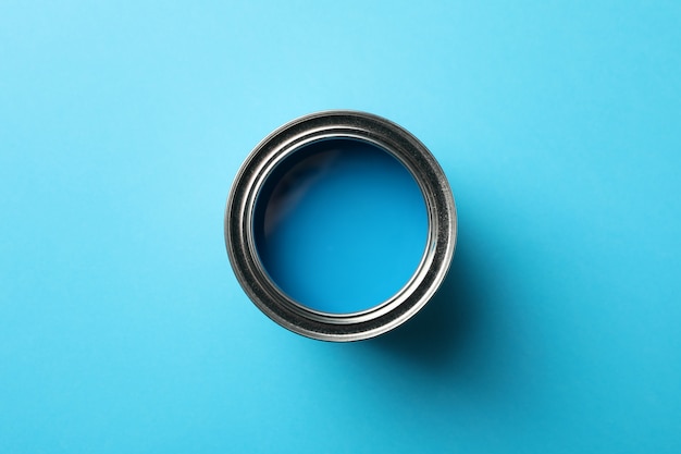 Paint can on blue background, top view