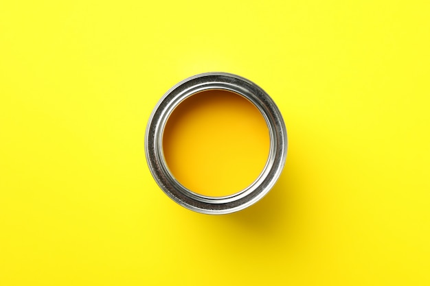 Paint can on yellow surface