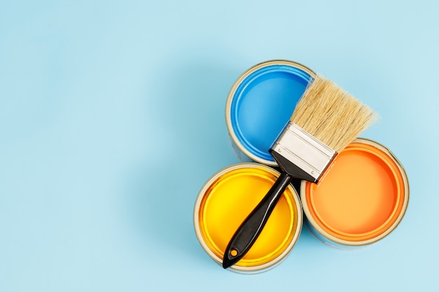 Paint cans and paint brushes and how to choose the perfect interior paint color and good for health