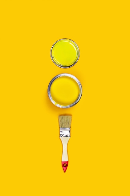 Paint jars on yellow background