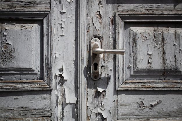 Paint peeled off old wooden door