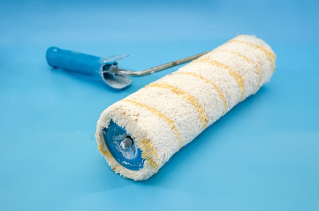 Photo paint roller on a blue surface