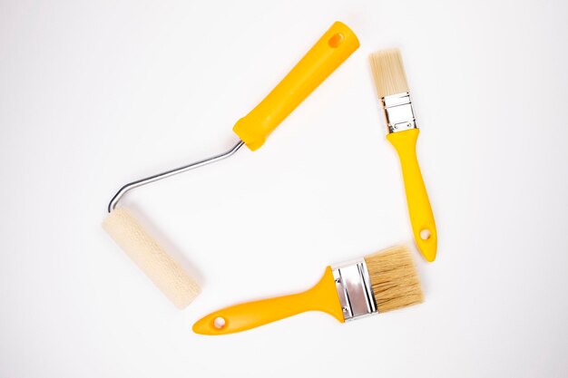 Paint roller, brushes on a white background. place for text
among the tools