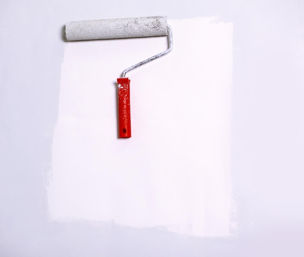 Photo paint roller painting on white paperbackground place for text