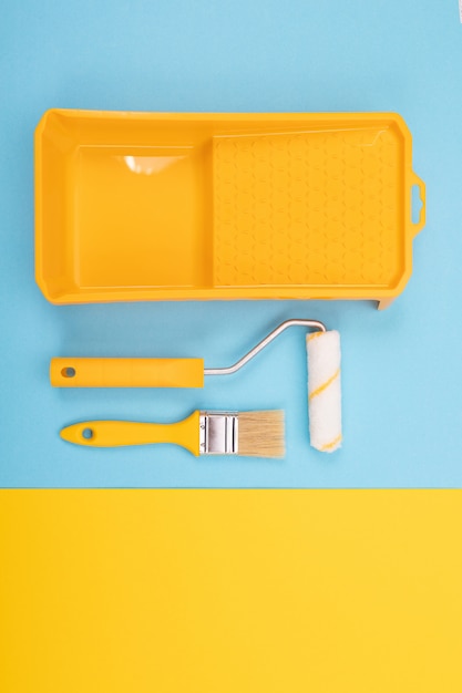 Paint tools. Paint brush and roller with tray for paint.