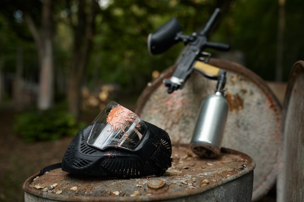 Paintball gun and protection mask closeup