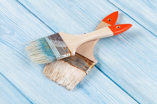 Paintbrush over blue wood