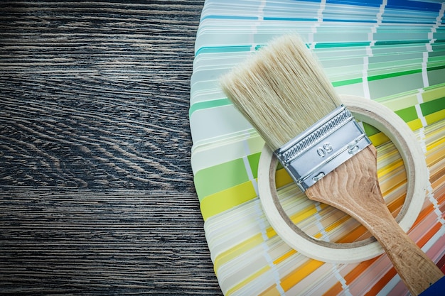 Paintbrush color pantone fan adhesive tape on wooden board