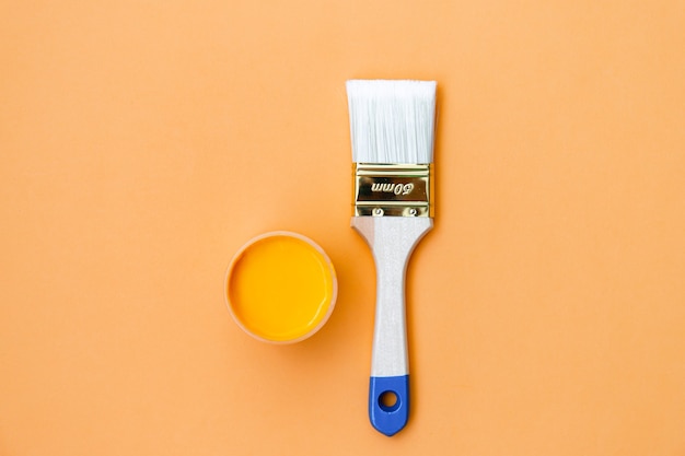 Paintbrush on orange background