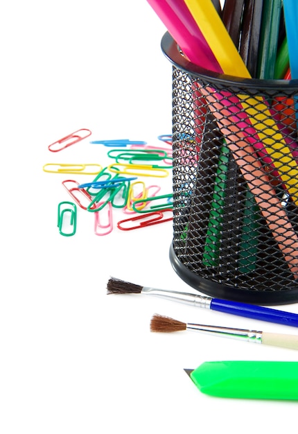 Paintbrush, paper clips and pencil in holder isolated