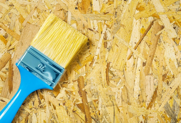 A paintbrush on plywood