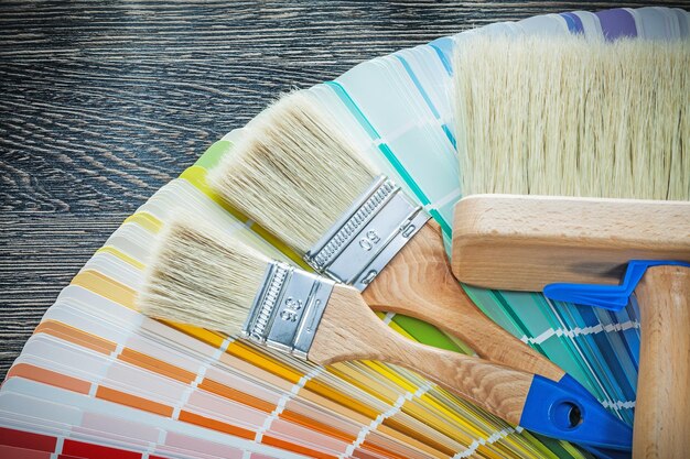 Paintbrushes color palette on wooden board