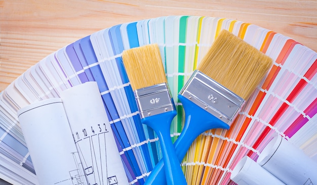 Paintbrushes on color palette and wooden boards