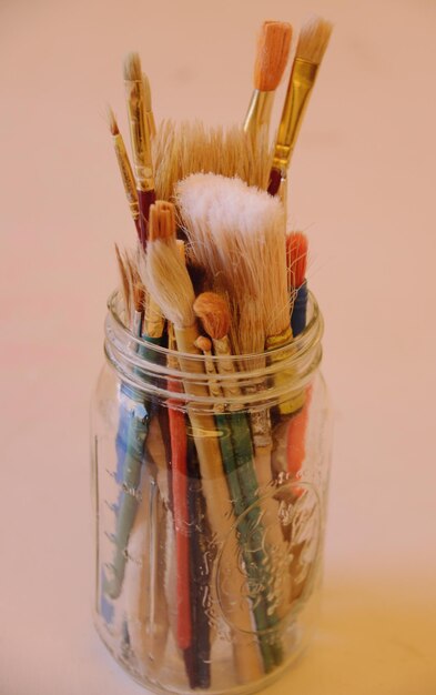 Photo paintbrushes in jar on table