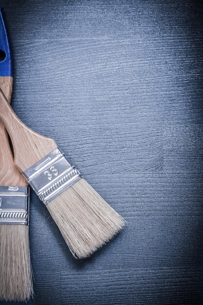 Paintbrushes with bristle on wooden board construction concept