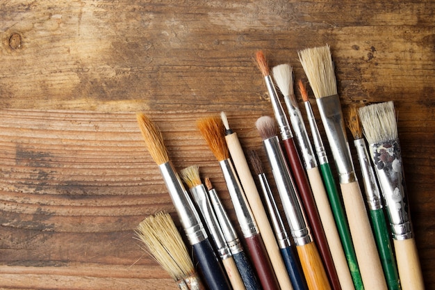 Paintbrushes on a wood background,