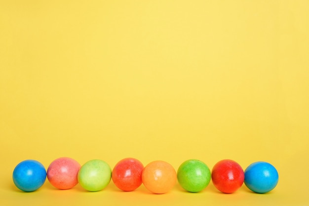 Painted colorful eggs for the Easter holiday yellow background.