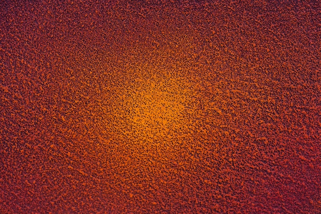 Painted concrete wall in red and orange with a gradient in the center