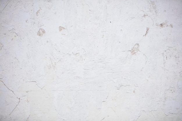 Painted concrete wall with scratches and cracks