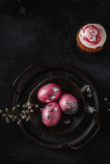 painted easter eggs on a black tray