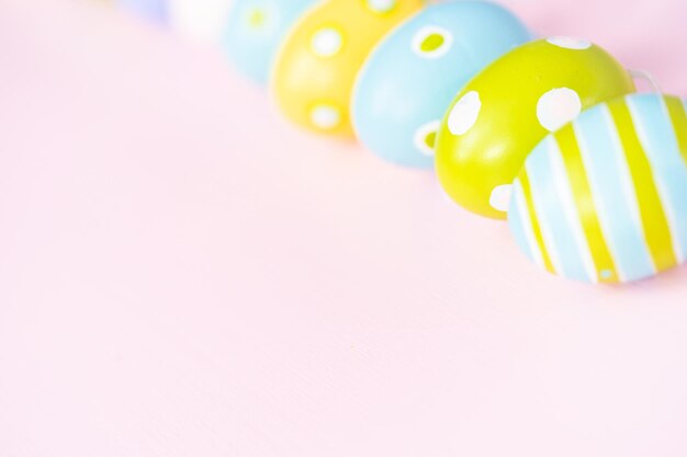 Painted Easter eggs on a pink background.